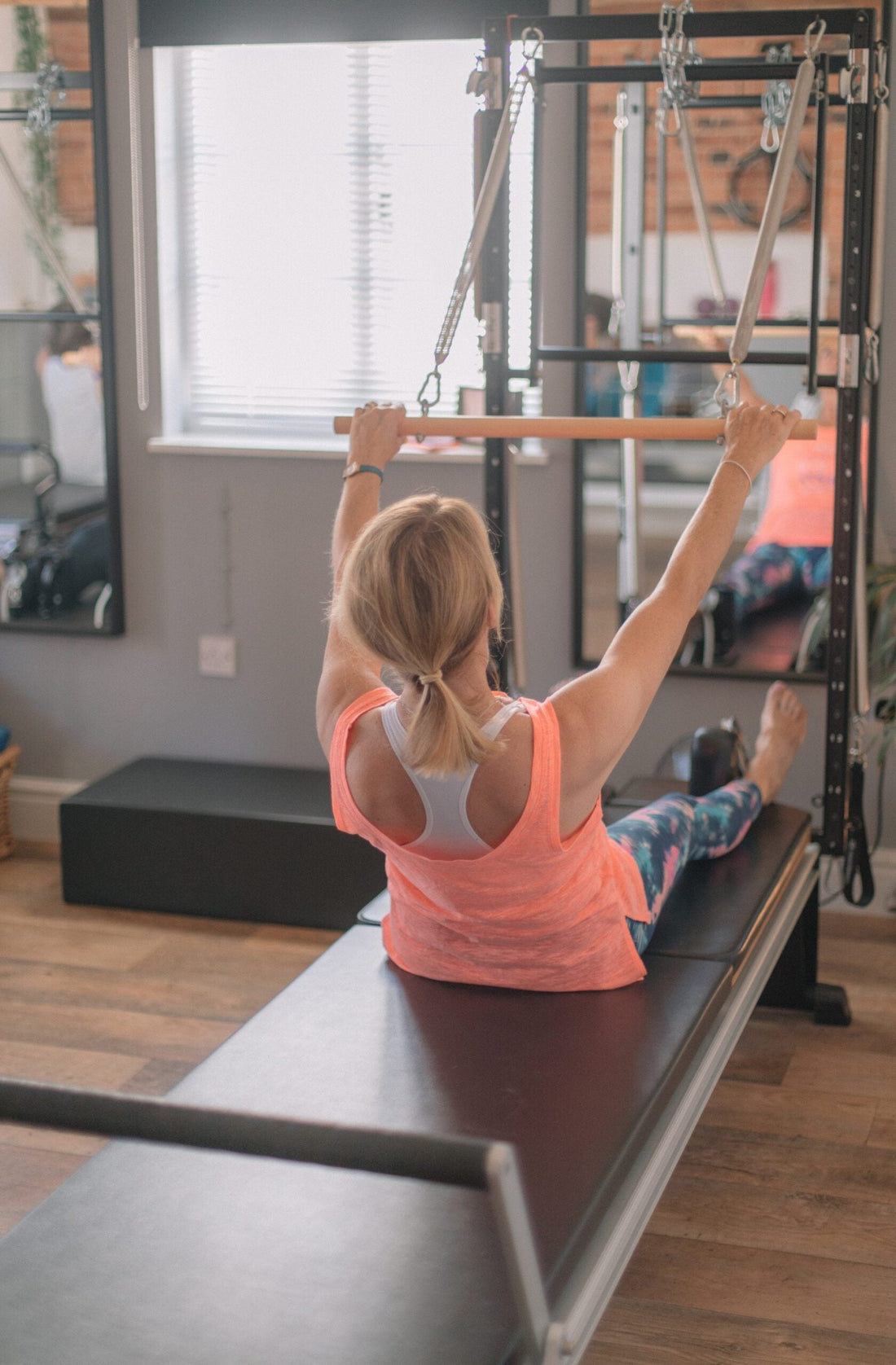 Client pulling the roll-up bar at the reformer tower