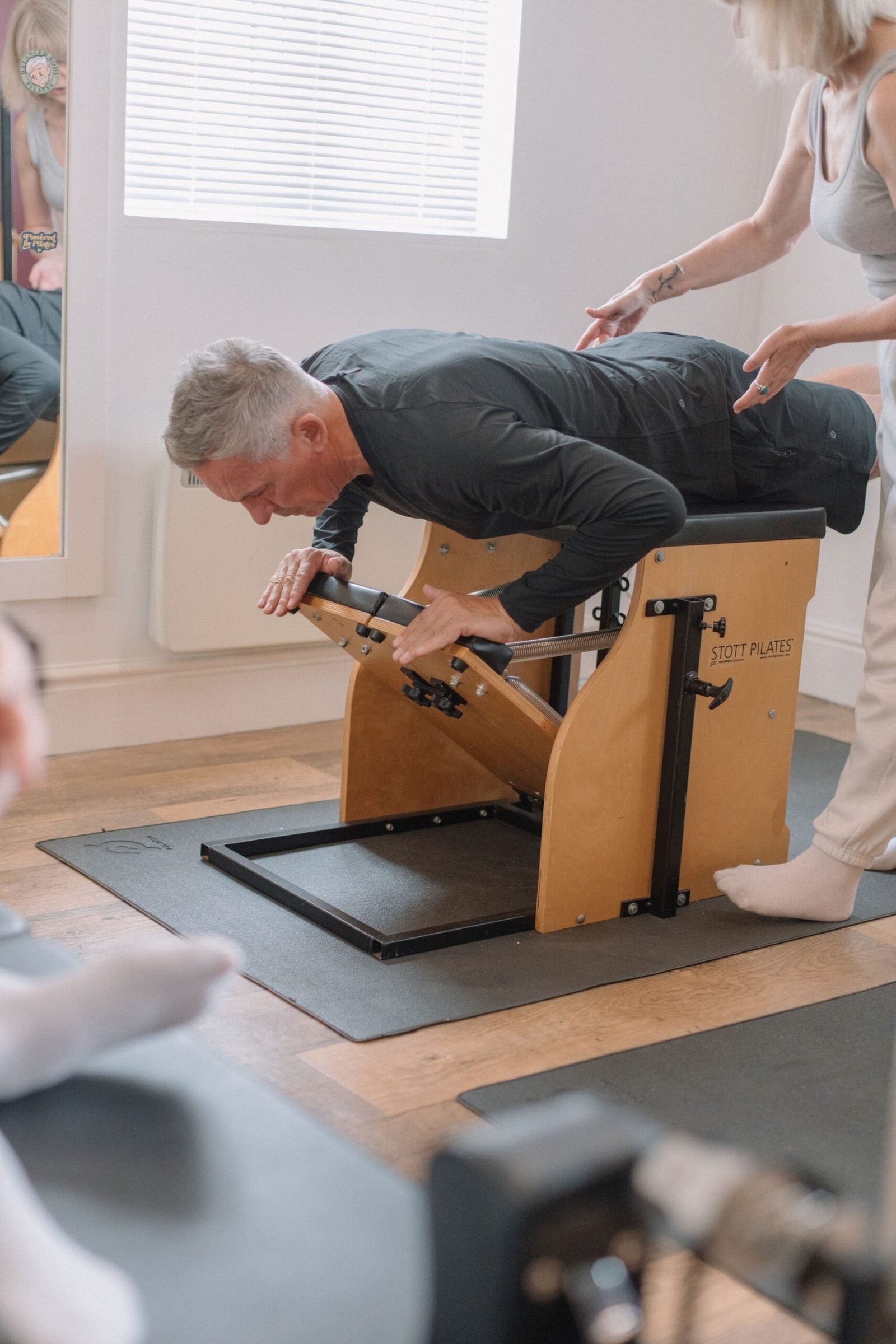 Male client working through a prone extension on the Pilates chair at The Old Dairy