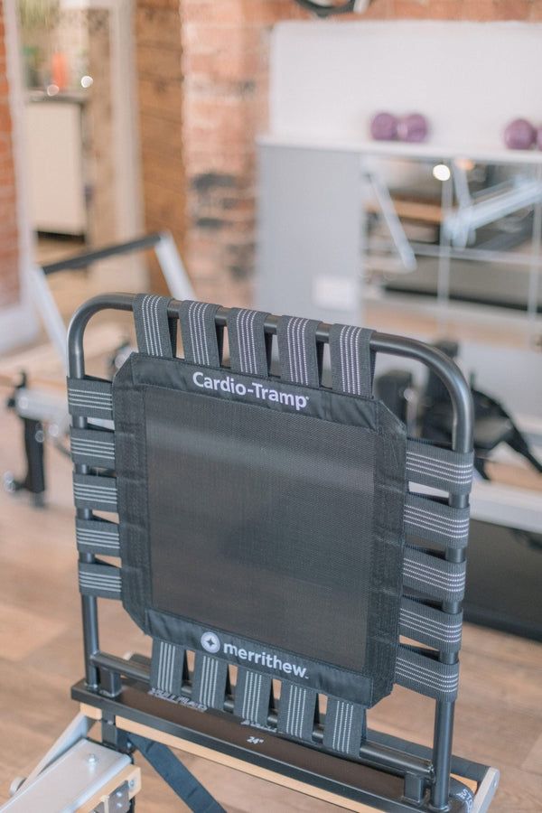 A Cardio-Tramp rebounder attached to the end of a reformer