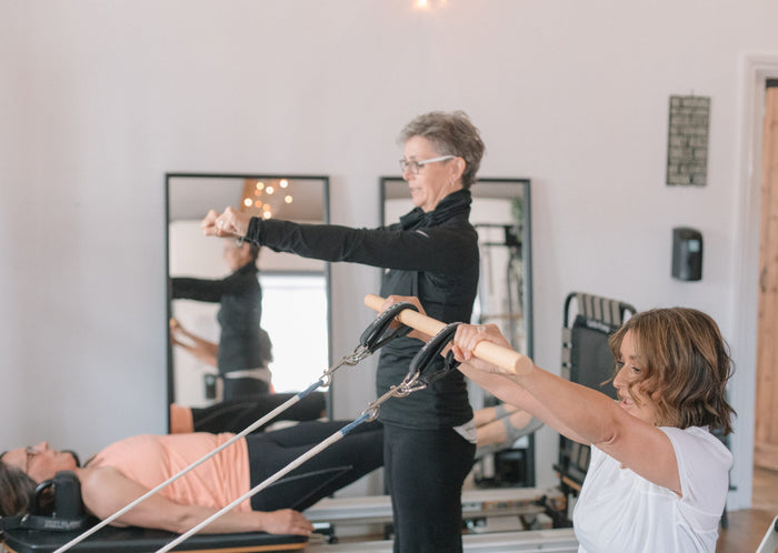Instructor leading a small-group reformer class